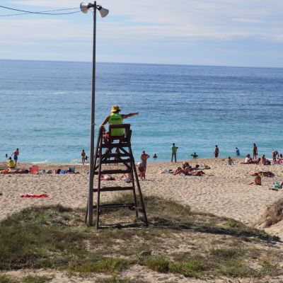 Lifeguard monitoring from his chair.