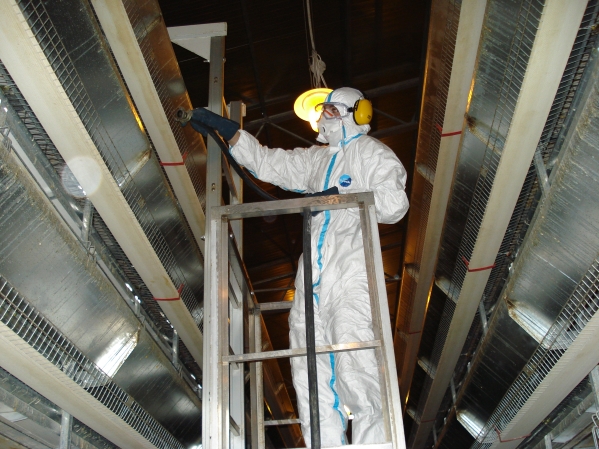 Worker disinfecting the poultry farm